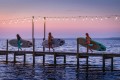 yolo-board-three-women-carrying-sups-on-pier.jpg